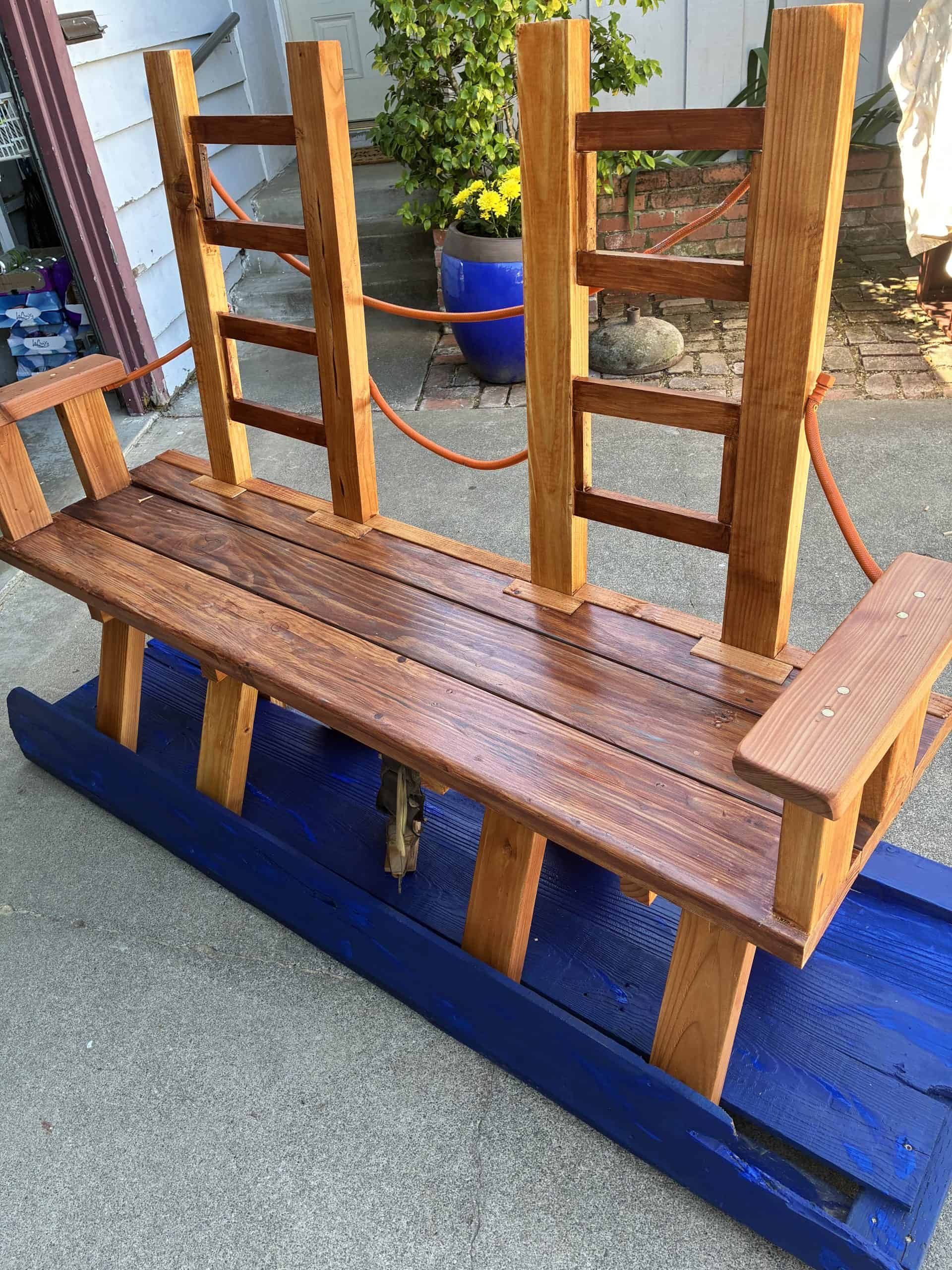 The seat slats are old fence boards, blended with several shades of stain.