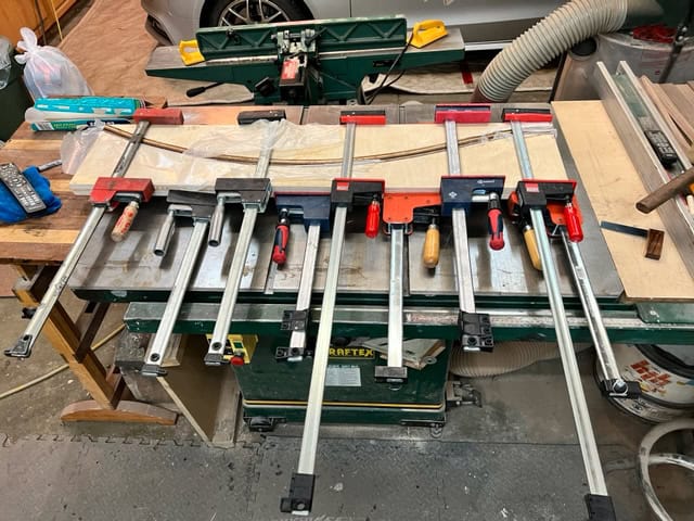 Bent-laminating the rockers on a shop-made form — clamps, and plenty of them.