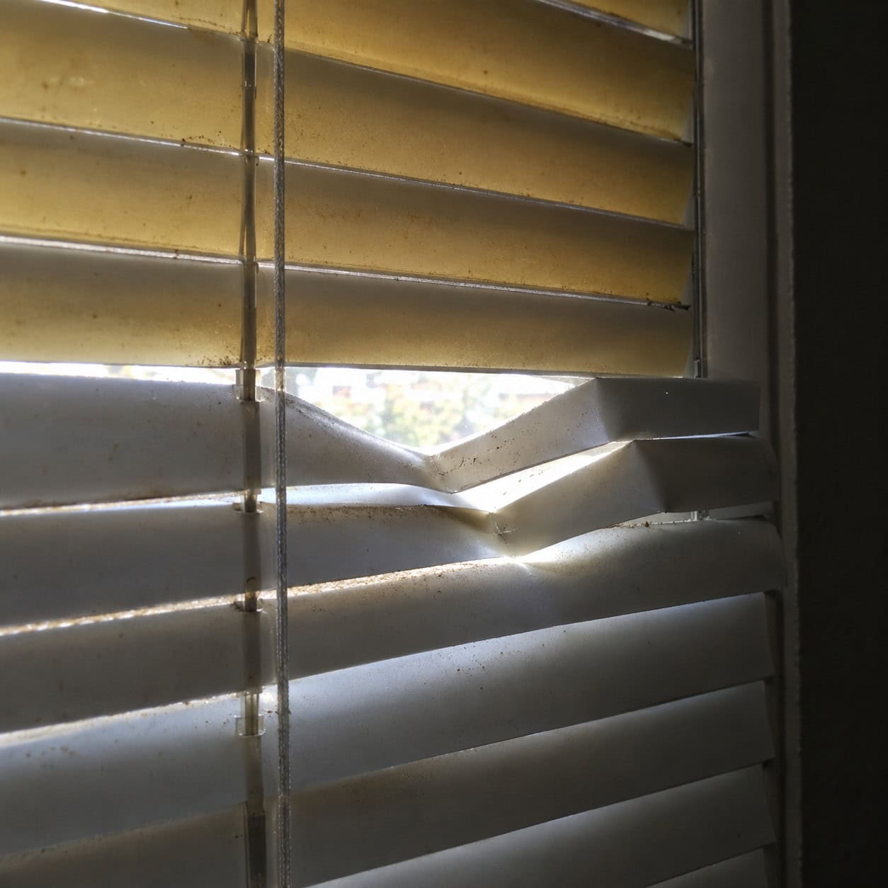 Yellowed Vinyl Mini Blinds With the Bent Slats