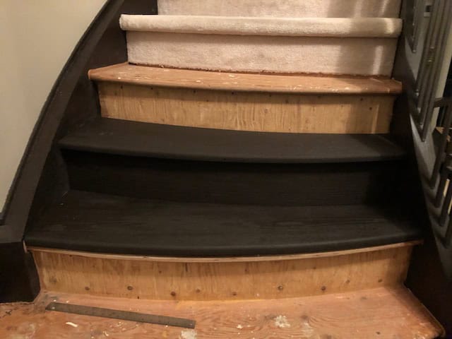 Test fitting finished treads partway up, with carpet still in place above.