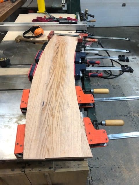 A tread glued up with Festool Domino joints and clamped across the bench.