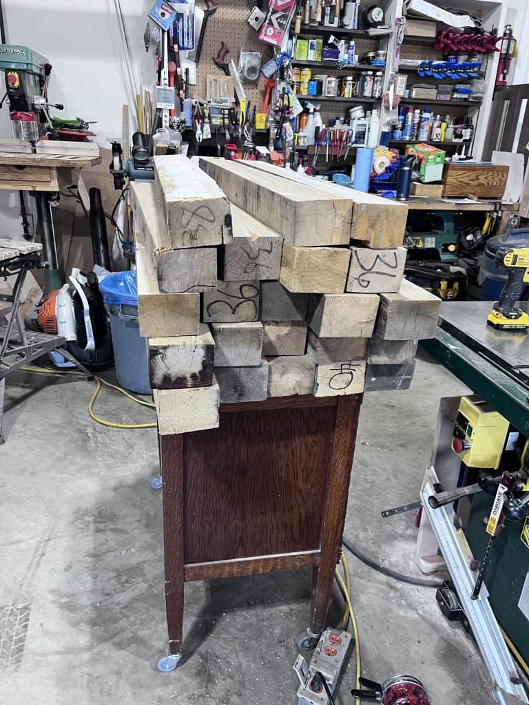 The repurposed maple stock, still rough and marked up, stacked before milling.