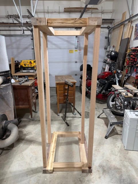 The oak base frame dry assembled and standing on end in the shop.