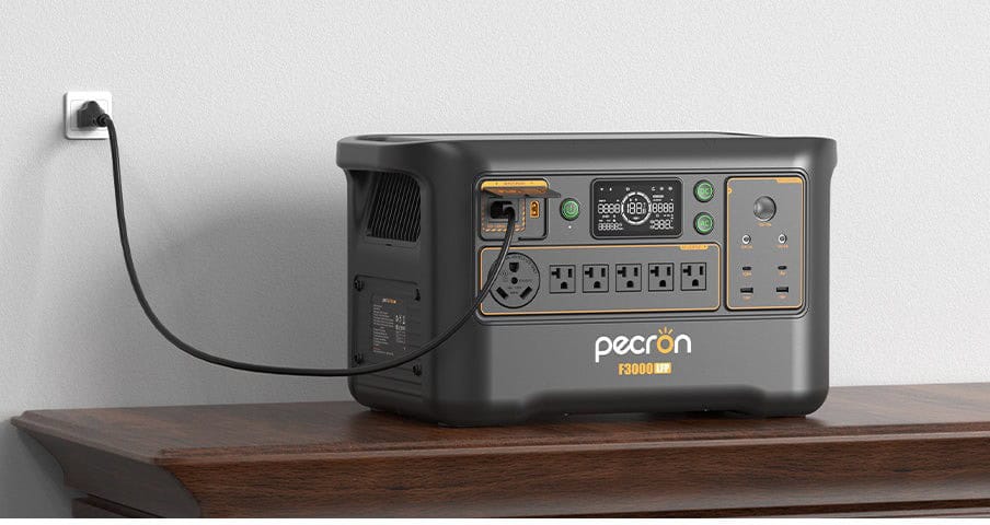 Pecron F3000LFP portable power station charging from a wall outlet indoors